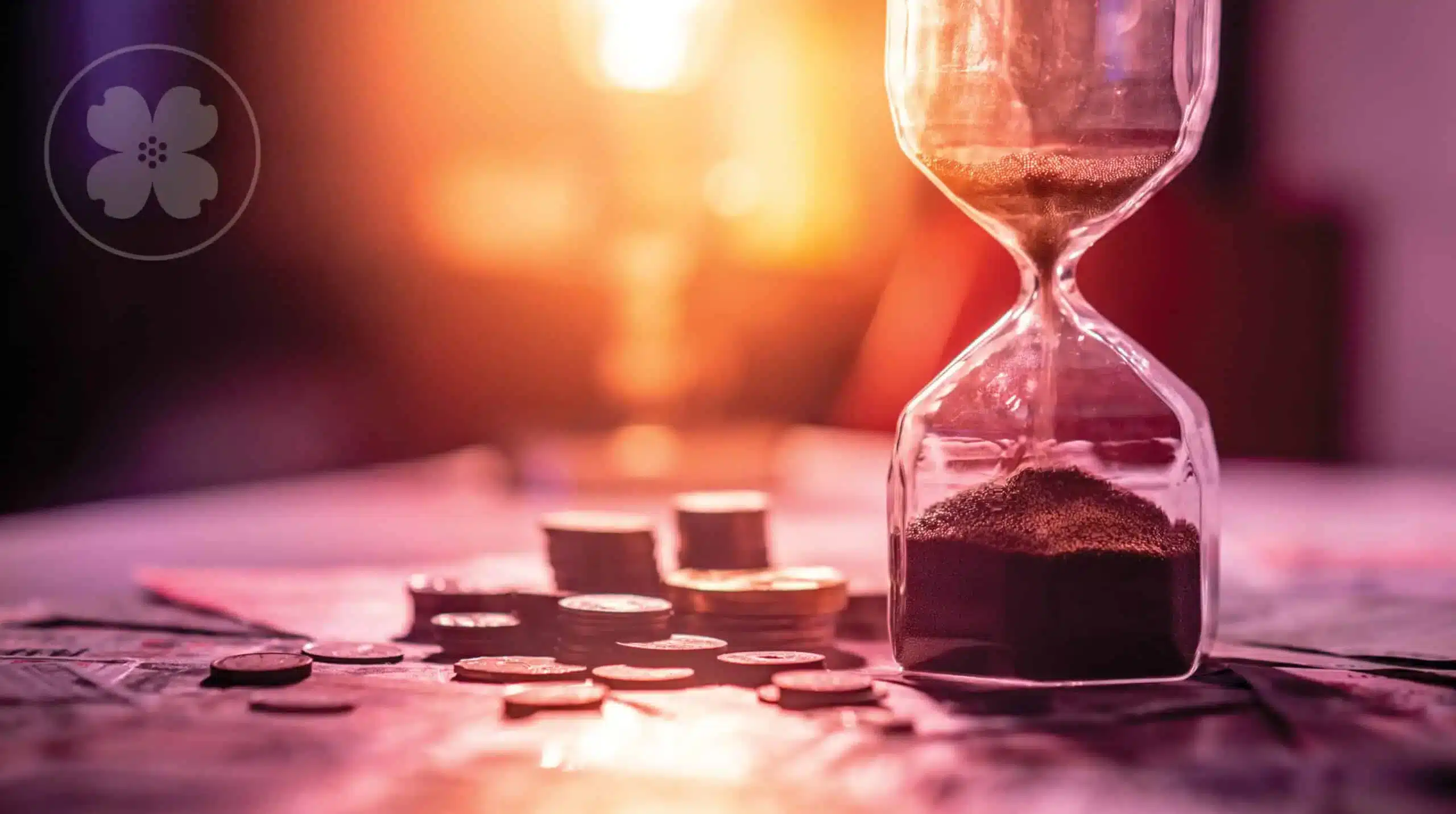 Hourglass ticking down next to a stack of coins.