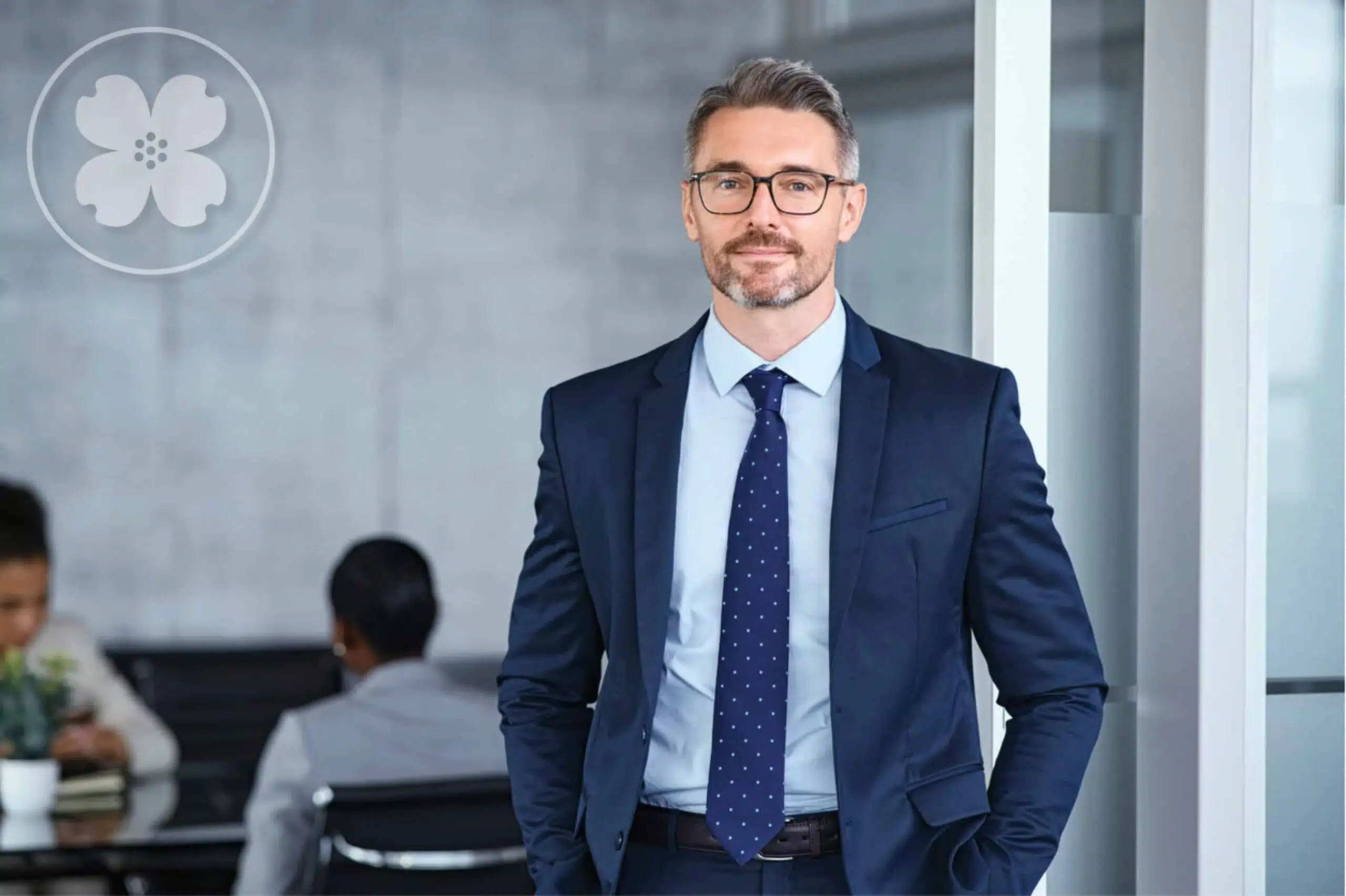 Employee standing in the office with a smile.